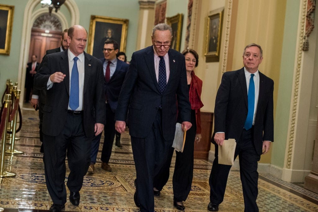 chris coons far left