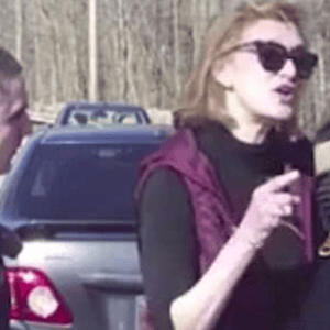 Clinton aide threatens cop