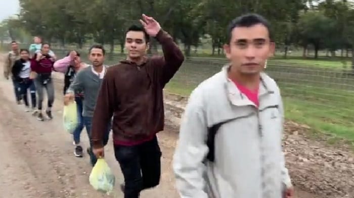 A video has surfaced showing hundreds of illegal immigrants crossing the southern border in Normandy, Texas, a vast majority of whom are single adults, appearing in good spirits and good shape, meeting absolutely no resistance from authorities.