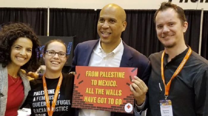 Senator Cory Booker, who was just forced to flee the Hamas terrorist attacks against Israel this past weekend, was seen in 2018 holding up a sign in support of pro-Palestine activists.