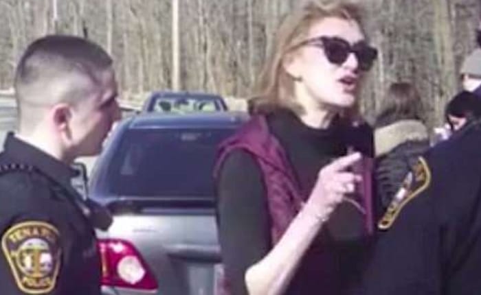 Clinton aide threatens cop
