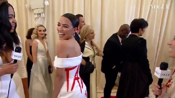 AOC arrived at the Met Gala, where tickets can go for as much as $30,000 each, wearing a designer gown with the words "Tax The Rich" scrawled across its back.