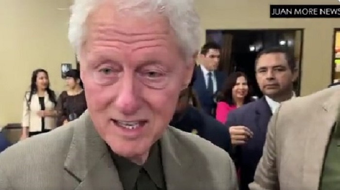 Bill Clinton was confronted by a reporter asking about his friendship with Jeffrey Epstein prompting an awkward response as the former President was ushered away by an aide.