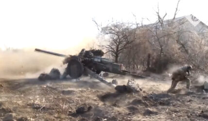 Ukrainian serviceman fires towed artillery against Russian troops.