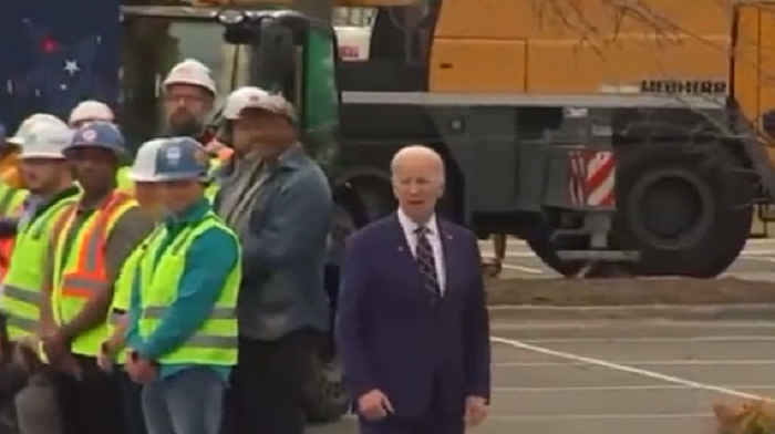A bizarre video clip appears to show a handler guiding President Biden step-by-step through the motions at a recent stop.