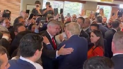 Former President Donald Trump joined supporters at a packed restaurant in Miami where they prayed for him and sang 'Happy Birthday.'