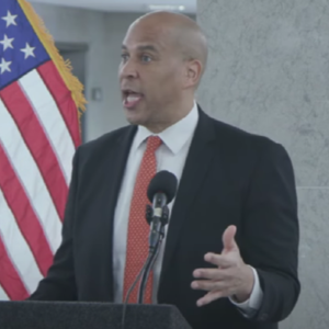 Senator Cory Booker initially celebrated a group of pro-Palestinian protesters interrupting a speech before attempting to drown them out with his own awkward effort.