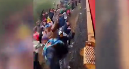 Shocking footage shows thousands of illegal immigrants lining train tracks in a desperate bid to hail a ride across the United States border just a few hours away.